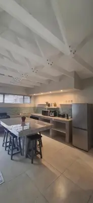 a large kitchen with a table and a counter at Kiewiets Nest in Victory Hill