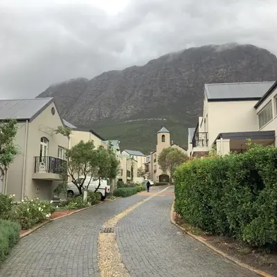 a street in a town with a mountain in the background at Apartment Franschhoek 121 Lermitage in Franschhoek
