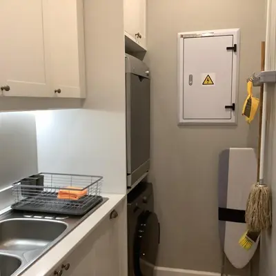 a small kitchen with a sink and a refrigerator at Apartment Franschhoek 121 Lermitage in Franschhoek