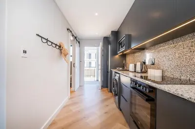 a kitchen with black cabinets and a counter top at 136 Paarl Studio With Onsite Parking Comforts in Paarl