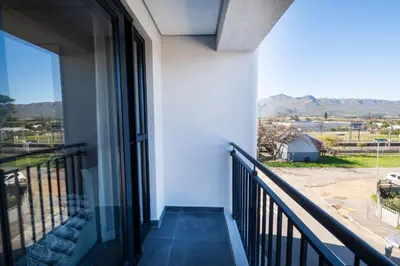 a balcony with a view of the mountains at Paarl 225 - Lux Modern 2 Bedroom Apartment with Parking in Paarl
