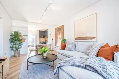 a living room with a couch and a table at Paarl 225 - Lux Modern 2 Bedroom Apartment with Parking in Paarl