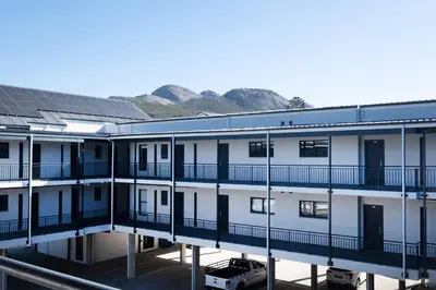 a view of a building with solar panels on it at Paarl 225 - Lux Modern 2 Bedroom Apartment with Parking in Paarl