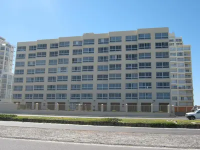 a building with a car parked in front of it at Aandvari Zeezicht in Cape Town