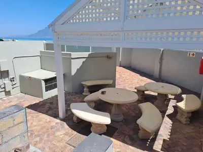 a group of picnic tables and benches on a boat at Aandvari Zeezicht in Cape Town