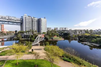 a bridge over a river next to a city at Waters Edge Apartments by Propr in Cape Town
