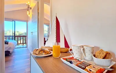 a breakfast table with a plate of food and orange juice at Beach House, Pool, Braai, Patio, Water Sports in Hermanus