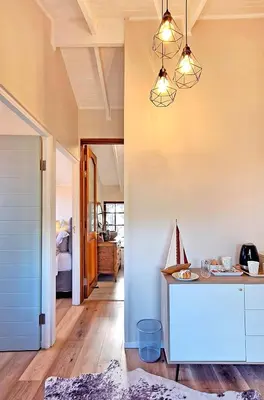 a kitchen with a island in a room at Beach House, Pool, Braai, Patio, Water Sports in Hermanus