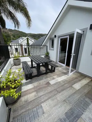 a patio with a picnic table on a house at Stay At Nantes in Paarl