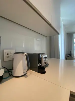 a microwave sitting on a counter in a kitchen at Serene Global Capetown Axis in Cape Town