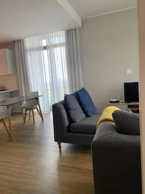 a living room with a couch and a table at Serene Global Capetown Axis in Cape Town