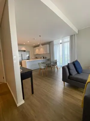a living room with a couch and a table at Serene Global Capetown Axis in Cape Town