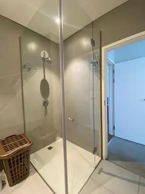 a shower with a glass door in a bathroom at Serene Global Capetown Axis in Cape Town