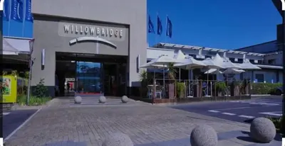 a shopping center with a building with umbrellas at Cosy Flatlet in Chrismar in Stikland
