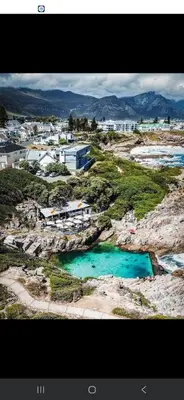 an aerial view of a city with blue water at Breakwater Nr 4 holiday apartment in Hermanus