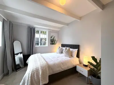 a bedroom with a large bed and a window at Secure & Central, Modern Flatlet in Cape Town