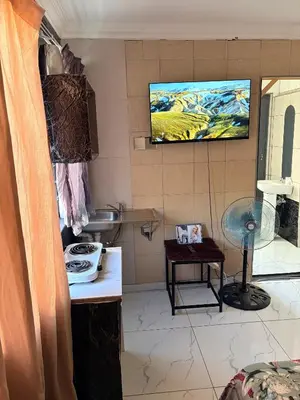 a bathroom with a sink and a tv on the wall at Browns villa and construction pty ltd in Cape Town