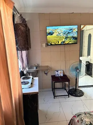 a bathroom with a sink and a tv on the wall at Browns villa and construction pty ltd in Cape Town