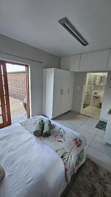 a bedroom with a large bed with two pillows on it at Protea Rus in Wellington