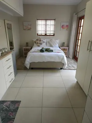 a bedroom with a bed and a tiled floor at Protea Rus in Wellington