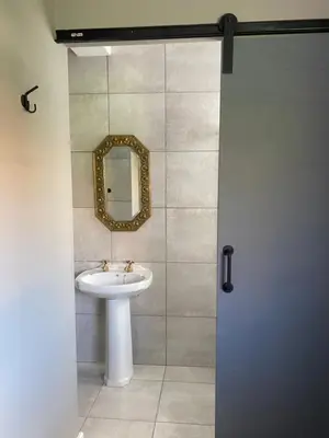 a bathroom with a sink and a mirror at The Perfect Spot in Welgelegen