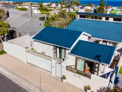 an overhead view of a white house with a blue roof at Mountain Rest Hermanus in Hermanus