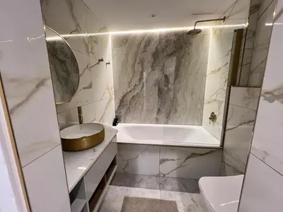 a white bathroom with a tub and a sink at Luxury Portico Apartment in Cape Town