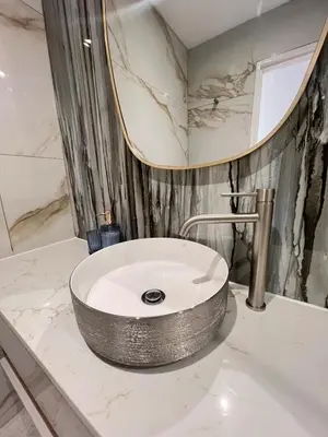 a bathroom with a sink and a mirror at Luxury Portico Apartment in Cape Town