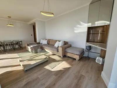 a living room with a couch and a table at Luxury Portico Apartment in Cape Town