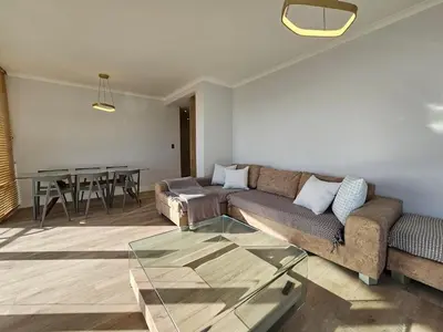 a living room with a couch and a glass table at Luxury Portico Apartment in Cape Town