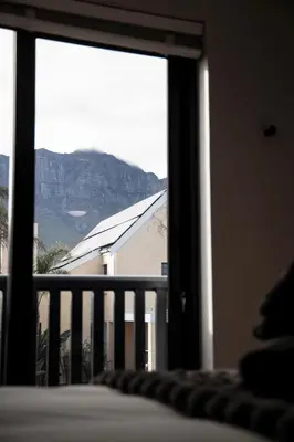 a bedroom window with a view of a mountain at Apartment Paradys 2 - Serviced in Stellenbosch