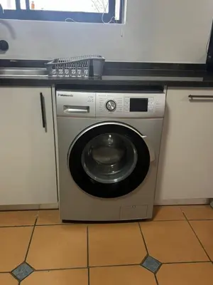 a washing machine in a kitchen next to a counter at Apartment Paradys 2 - Serviced in Stellenbosch