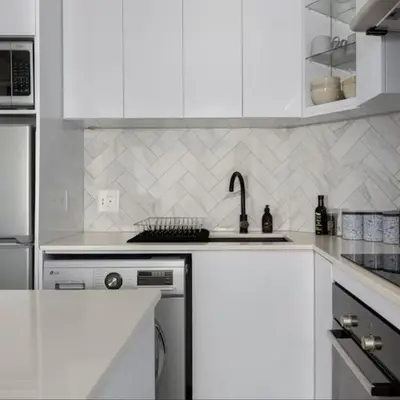 a white kitchen with a sink and a stove at JC Mountain View in Cape Town