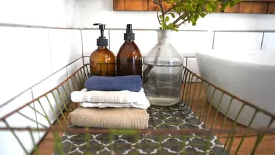 a metal rack with bottles and towels on a counter at The Art Room in Somerset West