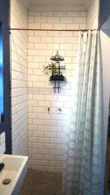 a bathroom with a shower curtain and a sink at The Art Room in Somerset West