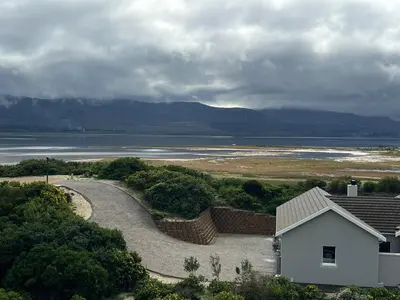 a house and a road next to a body of water at Lagoon & beach paradise in Lake Marina