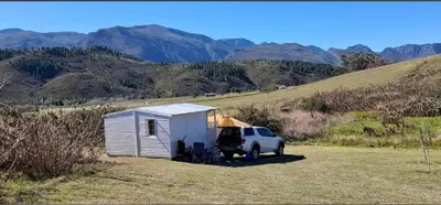 a white truck parked next to a tiny house at Cabin on Spinlea Farm Campsite in Caledon