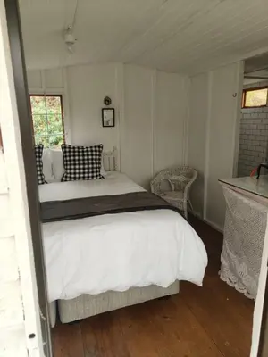 a bedroom with a large bed in a room at Cabin on Spinlea Farm Campsite in Caledon