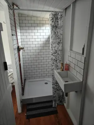 a bathroom with a shower and a sink at Cabin on Spinlea Farm Campsite in Caledon