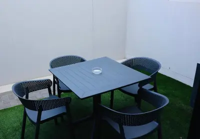 a blue table and chairs with a bowl on top at 21b on SANDOWN in Cape Town