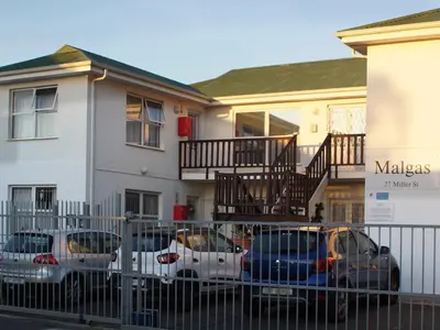 a group of cars parked in front of a house at Sea Urchin in Gordonʼs Bay