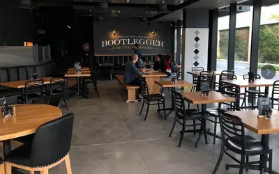 a restaurant with tables and chairs and people sitting at tables at Nine Palms - Century City Luxury Apartment in Cape Town