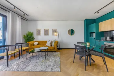 a living room with a couch and a table at Nine Palms - Century City Luxury Apartment in Cape Town