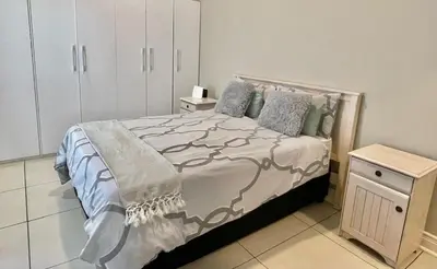 a bedroom with a large bed and a cabinet at Franschhoek Gem on Van Wijk in Franschhoek