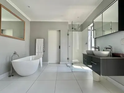 a bathroom with two sinks and a bath tub at Franschhoek Gem on Van Wijk in Franschhoek