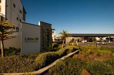 a building with a sign in front of a parking lot at #AlimamaSpaces Manson's Fynbos Villa in Cape Town