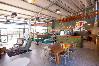 a restaurant with tables and chairs and a bar at #AlimamaSpaces Manson's Fynbos Villa in Cape Town