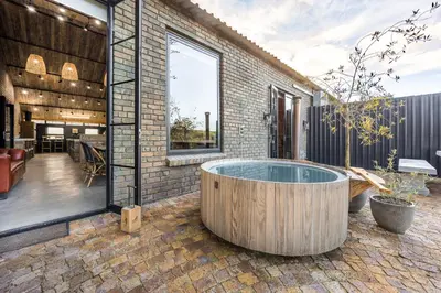 a jacuzzi tub in the middle of a patio at My Venue at Avemore in Onder-Papegaaiberg