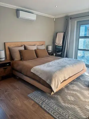 a bedroom with a large bed and a window at Pool & Garden Winelands Retreat in Stellenbosch