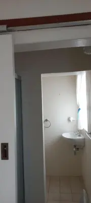 a bathroom with a white sink and a window at Cozy studio flat in Goodwood in Goodwood